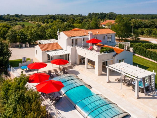 Luxurious villa with pool, fitness room, and children's playground for sale